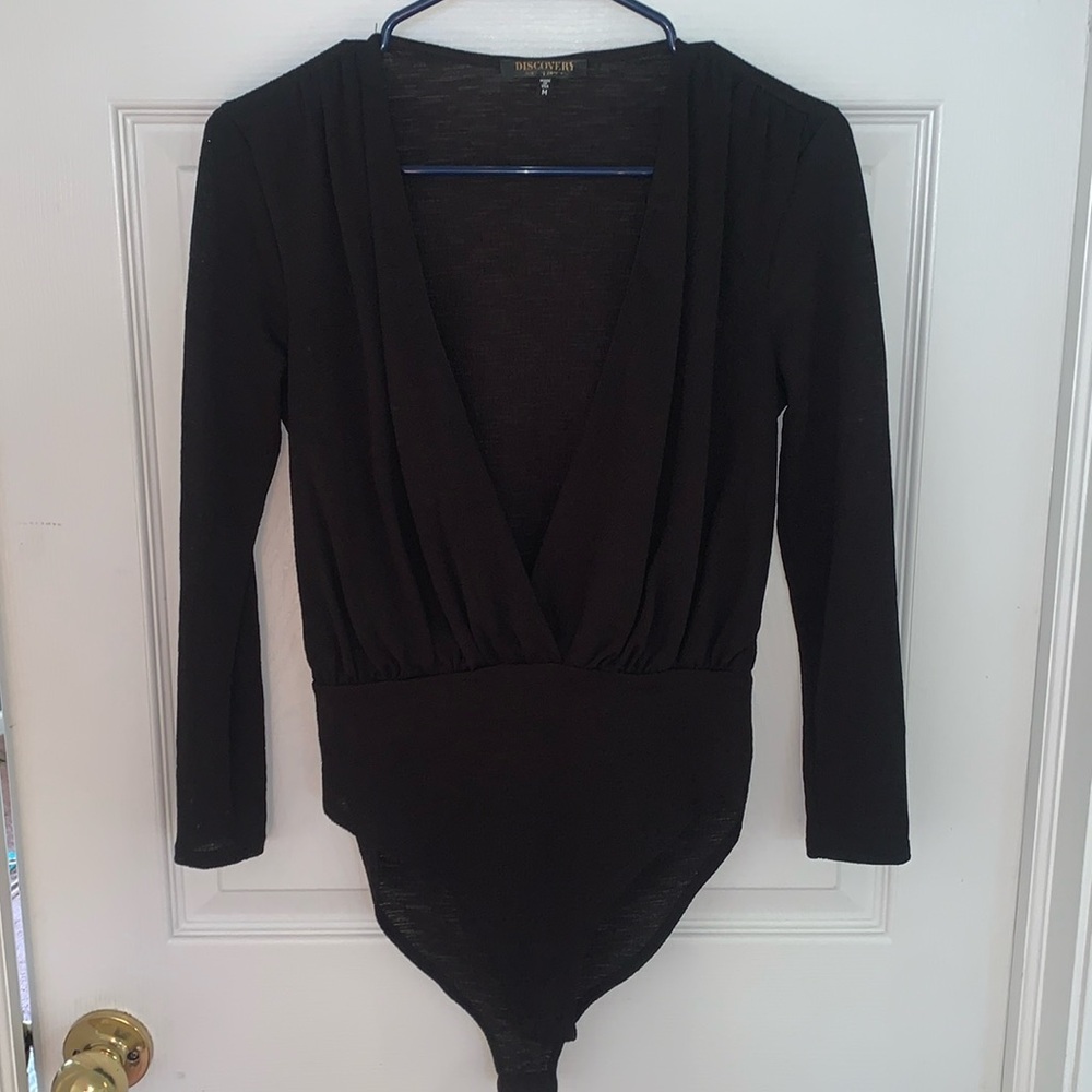 Deep v neck black bodysuit. Only worn twice!! Buttons in great shape
